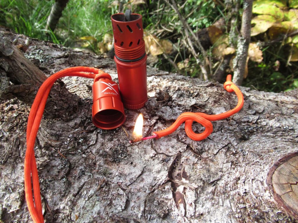 Colored inner of the Fire Cord lanyard being used to start fire