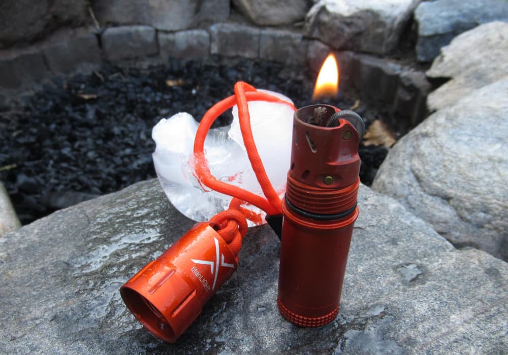 Defrosted Exotac TitanLight Lighter on rock in front of ice