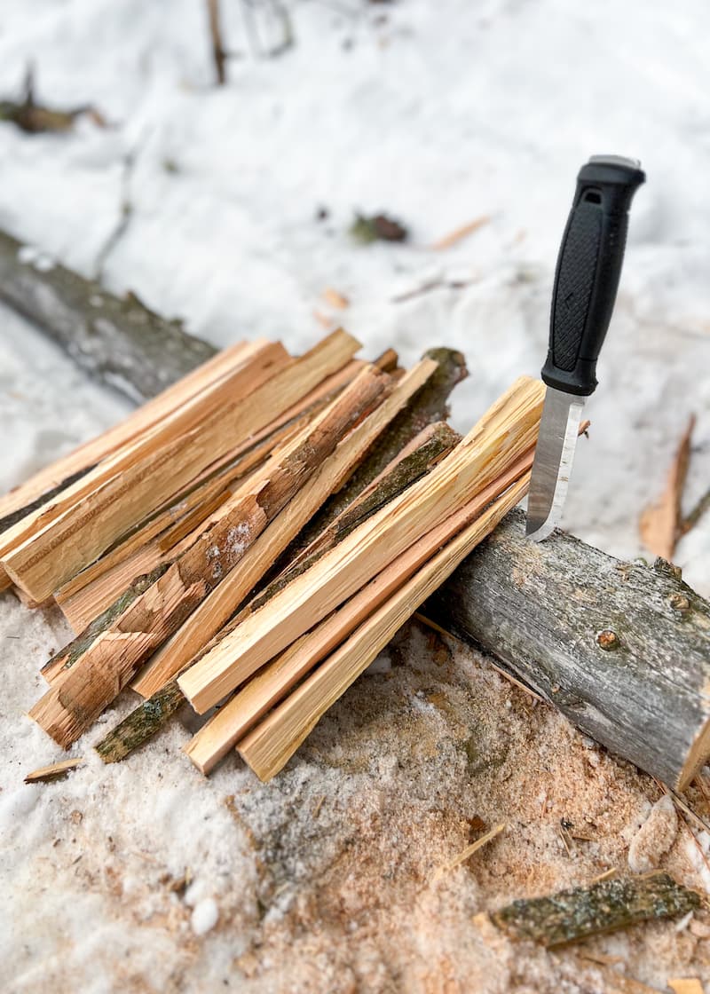 Mora Garberg with Tip in Wood Beside Kindling