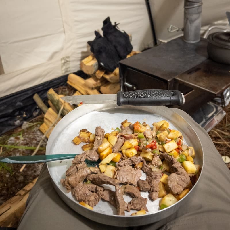 Mora Garberg on a Plate of Food in a Winter Tent