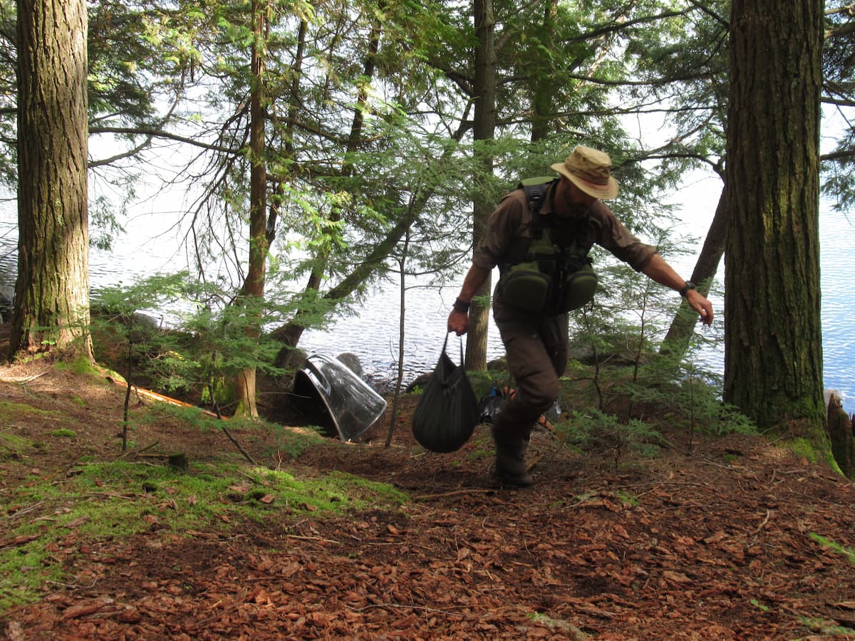 Man carrying water using the Savotta Water Carrying Bag