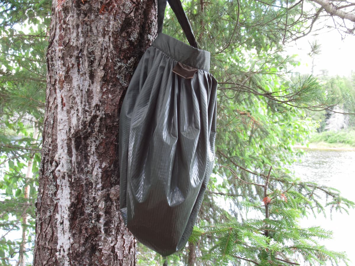 Savotta Water Carrying Bag hanging from a tree to dry