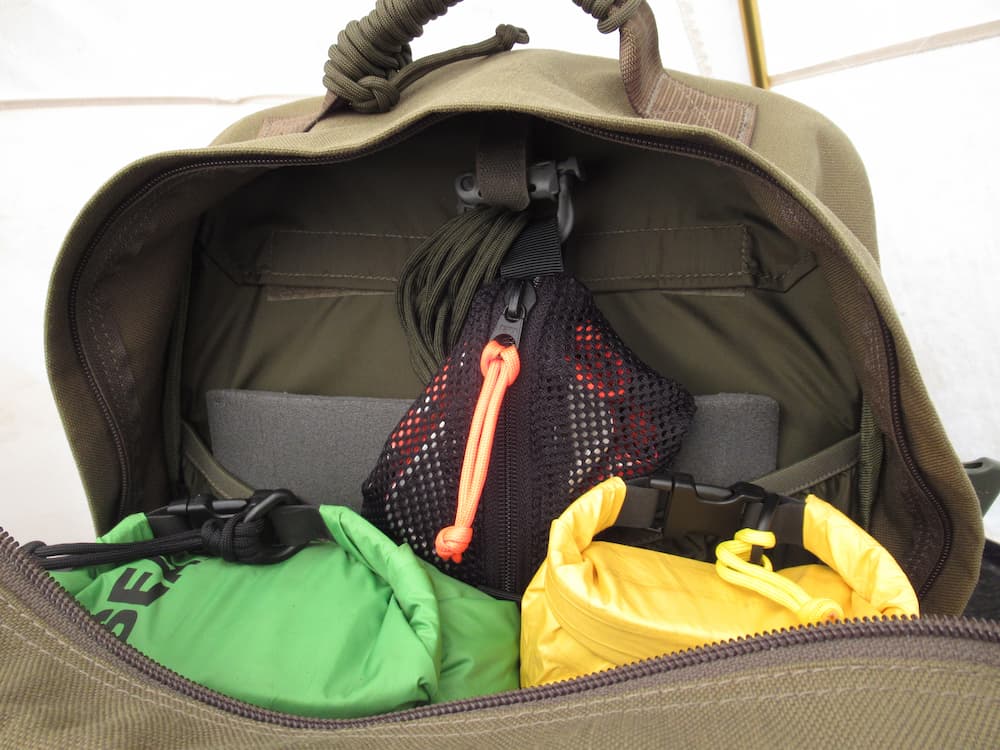 Savotta Small Trinket Pouch webbing loops in a backpack